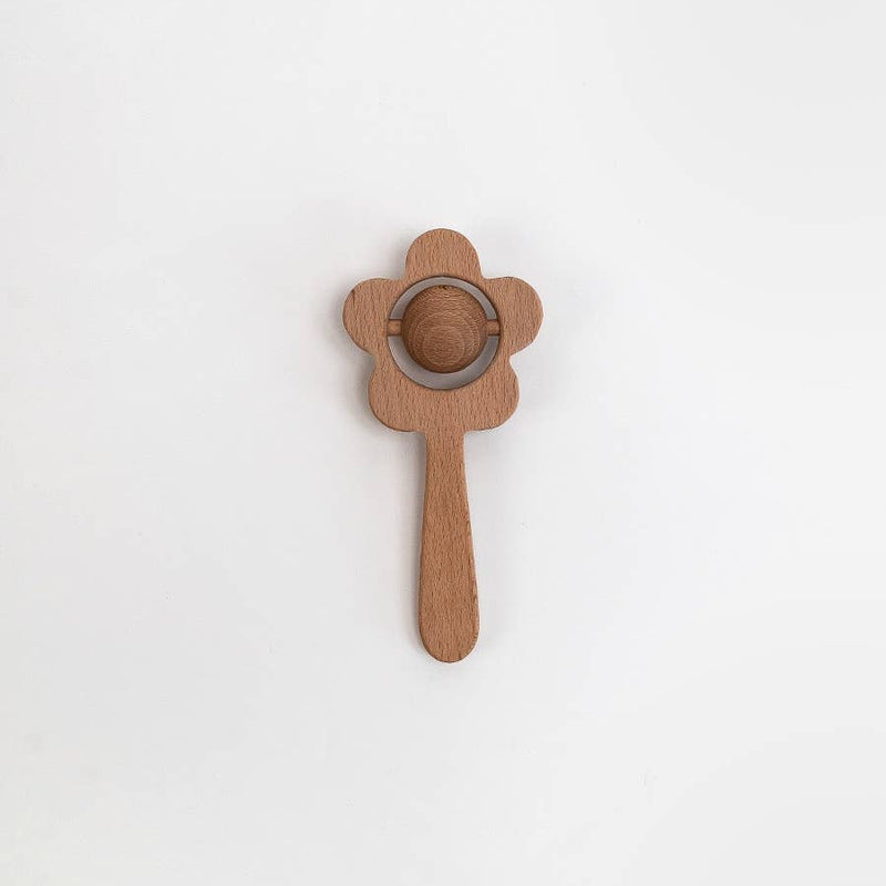 Wooden hairbrush with a circular metal clip on a white background