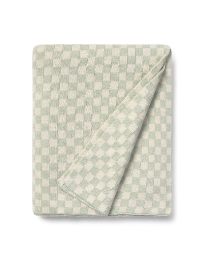 Folded checkered blanket with light green and white pattern on a white background