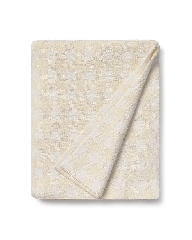 Folded beige blanket with subtle pattern on a white background
