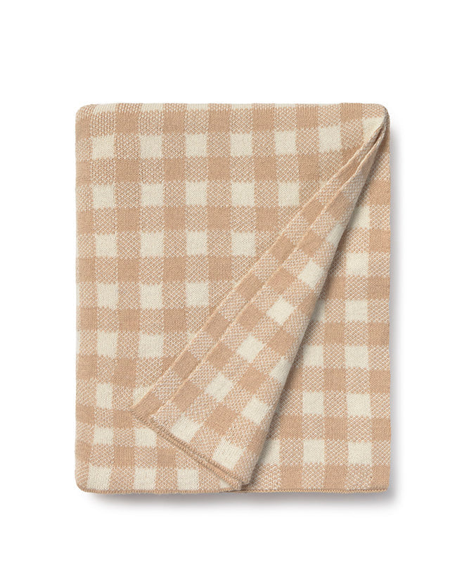 Folded beige and white checkered blanket on a white background