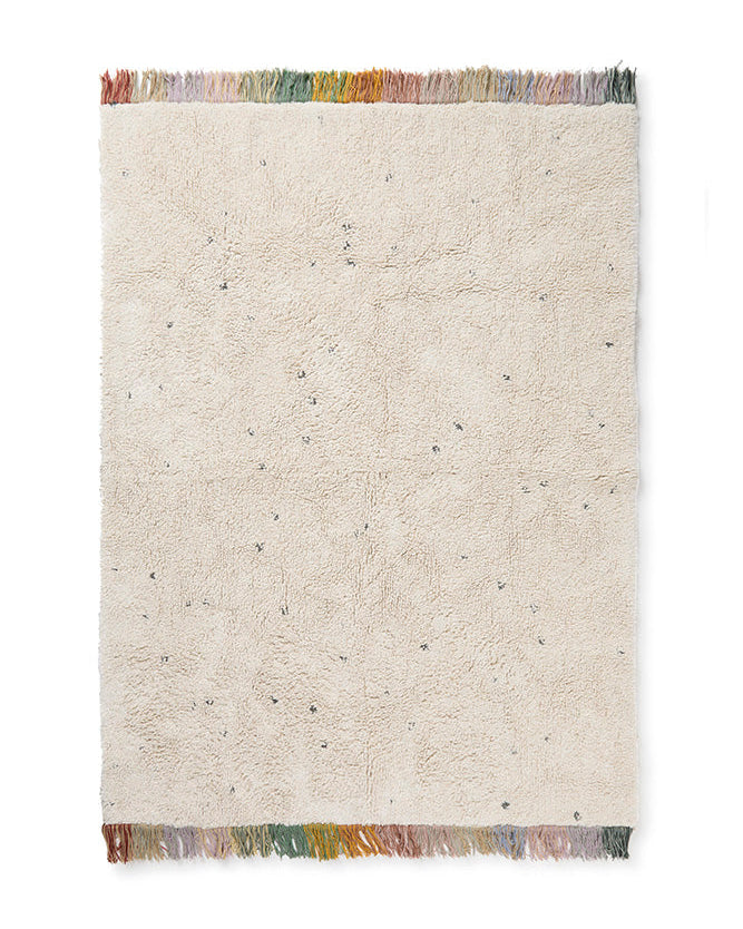 Beige textured rug with colorful fringe on a white background