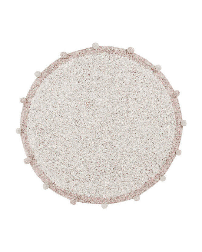Round textured rug with pom-pom trim on a white background