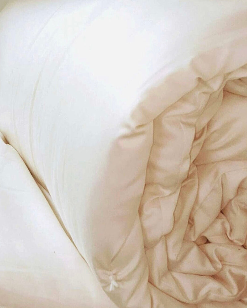 Close-up of beige bedding with a soft texture