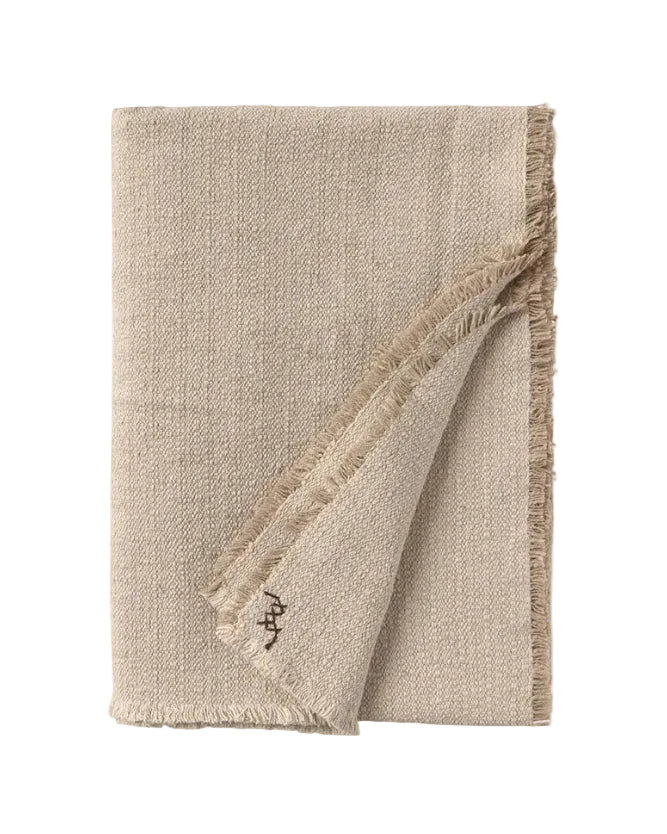 Beige woven blanket with frayed edges on a white background