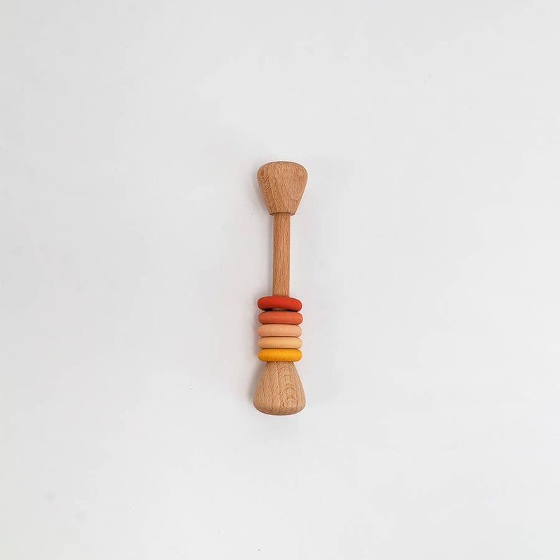 A wooden baby teether or sensory toy with a natural wood handle and colorful stacked beads in red, orange, and yellow, centered on a plain white background.