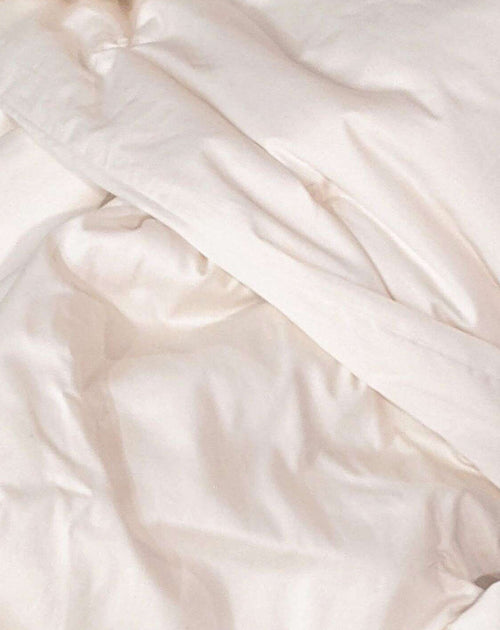 Close-up of white satin fabric with soft folds